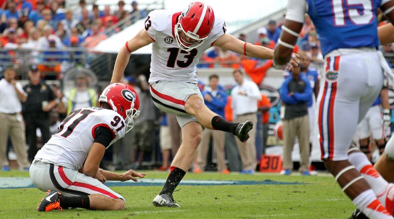 Georgia Bulldogs kicker Marshall Morgan (13) hits a 49-yard field goal as Georgia Bulldogs holder Adam Erickson holds in the first half of their game at Alltel Stadium Saturday afternoon in Jacksonville on November 2, 2013.