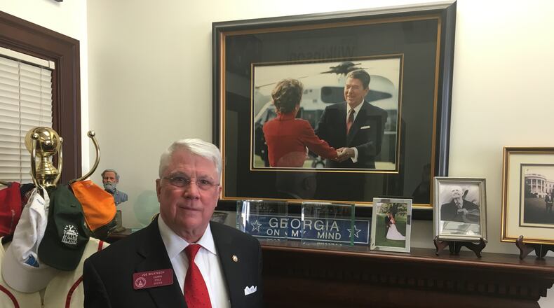 State Rep. Joe Wilkinson stands in front of a photo that Nancy Reagan gave him.
