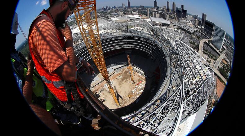Demand for construction workers seemed to peak in the past several years when they were needed for building two huge stadiums and a number of high-rises. Here, a worker takes in the view from the the top of Falcons Mercedes-Benz Stadium during the final stages of construction. Curtis Compton/ccompton@ajc.com