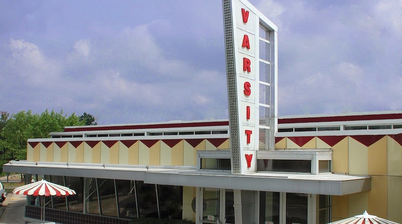 The Varsity turns 92 years old in August 2020! (Photo courtesy of The Varsity) Before The Varsity, there was this at North Avenue and Luckie Street. Frank Gordy called it The Yellow Jacket; and it came to be known by the Gordy family years later as the Varsity's training ground. (Photo courtesy of The Varsity) In 1928, with a $1,860 nest egg, Frank Gordy leased a house at 55 North Avenue, and constructed a small brick building in its front yard. He felt he could take advantage of the foot traffic from the nearby trolley stop. (Photo courtesy of The Varsity) The ledger of account from the first 4 months of The Varsity's operation notes its immediate success. On the 1st day of business, while hot dogs only cost 5 cents, the business made $47.30. (Photo courtesy of The Varsity) Gordy expanded his business. He added on to the original building, opening a barbershop in November 1928. By 1930, Gordy had expanded again, moving the barbershop over & putting a bowling alley in the old shop location. (Photo courtesy of The Varsity) Frank Gordy pictured here with his wife Evelyn on their honeymoon in 1930. (Photo courtesy of The Varsity) On March 11, 1932 Gordy opened his 2nd Varsity restaurant in Athens, across the street from the Arch at UGA. Gordy had a vision that he could repeat his formula by opening restaurants on major college campuses.(Photo courtesy of The Varsity) John Railford began working at The Varsity in 1937. His flamboyant mannerisms earned him the nickname Flossie Mae. Grand Ole Opry star Minnie Pearl gave him a hat & he started decorating them. He sang the menu, too. (Photo courtesy of The Varsity) In the 40s, The Varsity underwent a major makeover. The concept was designed to make the building look as streamlined as the cars now pulling in for service. (Photo courtesy of The Varsity) While the great majority of The Varsity's business continued to be outside in its parking lot, the new design helped provide more counter space for customers to stand and eat inside. (Photo courtesy of The Varsity) In 1948, television was still in its infancy. WSB TV went on air September 19, 1948, in Atlanta, and Gordy Felt his customers should be able to watch it as it grew. Gordy installed a TV in one of the dining rooms. (Photo courtesy of The Varsity) By 1950, The Varsity had claimed the title of The World's Largest Drive-In. Meet Me at The Varsity was catching on. This 1951 Holiday Magazine picture offers a glimpse of a typical weekend. (Photo courtesy of The Varsity) A view of The Varsity in the 50s. (Photo courtesy of The Varsity) Erby Walker was another famous Varsity employee. He started working in 1952 at the age of 15 and worked for 55 years. When he started, he didn't ask how much he would make but rather how many hot dogs he could eat. (Photo courtesy of The Varsity) After the state took much of the parking lot for highway construction, Gordy built "The Lunching Pad" with 100 parking spots. Once built, the restaurant could handle 630 cars. (Photo courtesy of The Varsity) The 1960s brought another remodel of The Varsity's exterior. The plan called for panels made of six gauge steel with a baked enamel finish to be attached to the existing building. (Photo courtesy of The Varsity) The world was changing in 1962 and with more UGA students having cars, Gordy opened The Varsity Drive-in as the students ventured further from campus. It opened exactly 32 years after the original Athens location. (Photo courtesy of The Varsity) Gordy opens The Varsity Jr. on Lindbergh Avenue in 1965 It was one of John Portman's first designs. It closed for good in 2010 after 45 years of operation. following a zoning dispute with the city. (Photo courtesy of The Varsity) Field trips to The Varsity by Atlanta area school children have been a tradition since the 1960s. The photograph here shows the arrival of a group of students from Lovett School in Atlanta. (Photo courtesy of The Varsity) <p>The Varsity did not have enough storage to keep up with the volume of food it was serving. Gordy implemented the motto, "No food over 12 hours old" meaning whatever a customer ate had arrived less than 12 hours earlier.</p> <p>In 1983, Frank Gordy lost with battle with emphysema and died. The Varsity closed the day he was buried, the first time it had closed for a day in 55 years. (Photo courtesy of The Varsity)</p> <p>Nancy Gordy Simms, daughter of Frank Gordy, began training to run The Varsity in the early 1980s under the watchful eye or longtime manager Ed Minix. (Photo courtesy of The Varsity)</p> <p>An aerial view of The Varsity in the 80s. (Photo courtesy of The Varsity)</p> <p>Three generations are photographed here during The Varsity's 60th anniversary celebration in 1988. From left to right, Carrie Muir Browne, Nancy Gordy Simms, and Evelyn Gordy-Rankin. (Photo courtesy of The Varsity)</p> <p>In 1990, the first new Varsity in more than 20 years opened its doors in Gwinnettt County with a third generation Gordy at the helm. Gordon Muir was the manager. (Photo courtesy of The Varsity)</p> <p>In 1999, The Varsity opens in Kennesaw. (Photo courtesy of The Varsity)</p> <p>In 2011, The Varsity opened in Dawsonville. (Photo courtesy of The Varsity)</p>
