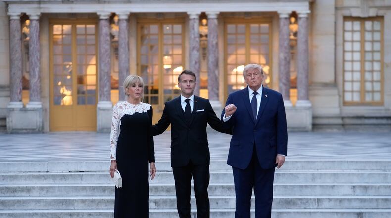 France's President Emmanuel Macron, center, his wife Brigitte, left, and U.S. President Donald Trump pose before a private dinner to celebrate the USA's 250th birthday, at the Palace of Versailles, outside Paris, Wednesday, June 17, 2026. (AP Photo/Michel Euler)