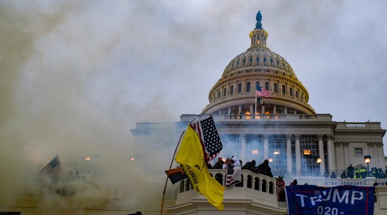 FILE — Rioters force their way into the Capitol in Washington, Jan. 6, 2021. The justices will hear arguments on Tuesday, April 16, 2024 in a case that could alter hundreds of prosecutions for the assault on the Capitol and help define its meaning. (Kenny Holston/The New York Times)