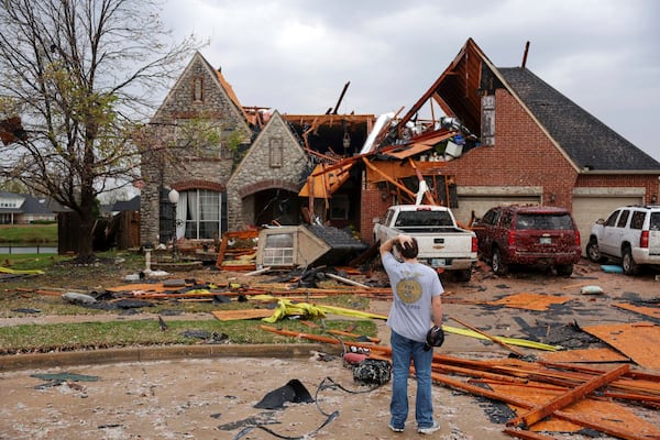Ryland Mosley, 18, who was on the 2nd story of his home when the storm passed, stands outside of it observing the damage, Wednesday, April 2, 2025 in Owasso, Okla. (Mike Simons/Tulsa World via AP)