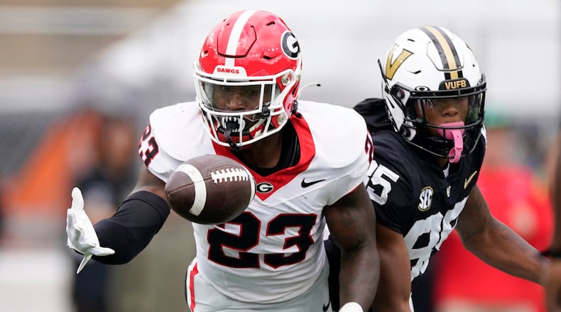 Georgia defensive back Tykee Smith (23) makes an interception against Vanderbilt wide receiver Junior Sherrill, right, in the first half of an NCAA college football game Saturday, Oct. 14, 2023, in Nashville, Tenn. (AP Photo/George Walker IV)