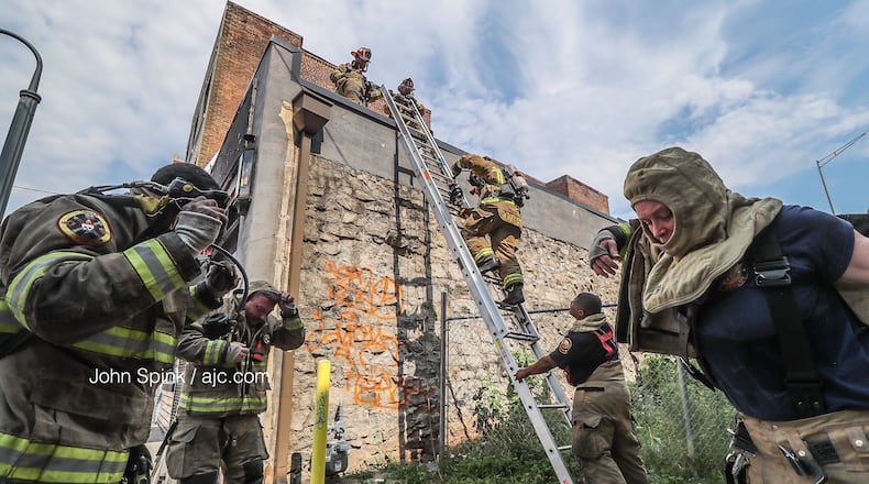 Atlanta Fire Rescue crews are investigating a three-story blaze at Auburn Avenue and Bell Street.