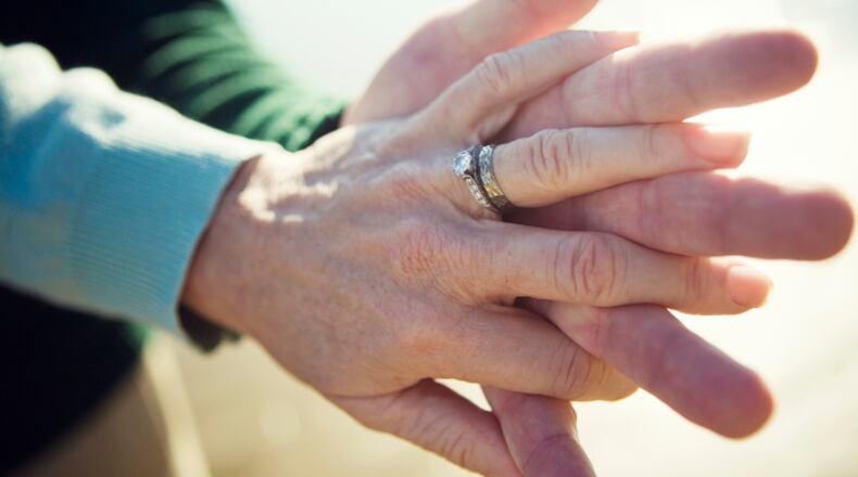 Senior couple holding hands (stock photo).
