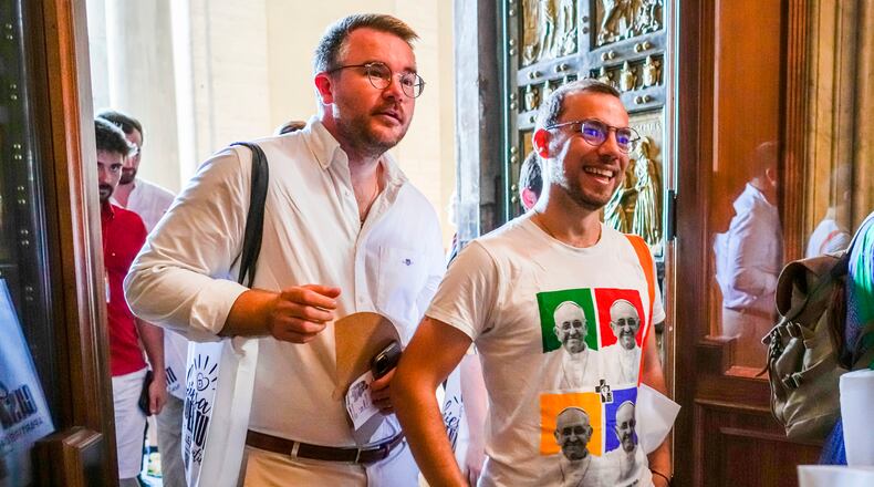 FILE - Members of the LGBTQ+ Catholics and their families who joined a Holy Year pilgrimage to Rome walk through the Holy Door of St. Peter's Basilica at the Vatican, Saturday, Sept. 6, 2025. (AP Photo/Andrew Medichini, File)