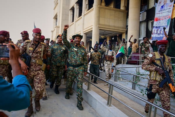 Sudan's military chief Gen. Abdel-Fattah Burhan center, is greeted by troops as he arrives at the Republican Palace, recently recaptured from the Rapid Support Forces paramilitary group, in Khartoum, Sudan, Wednesday, March 26, 2025. (AP Photo)