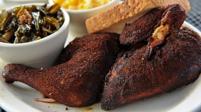 BBQ dry rub and smoked 1/2 chicken with mac n' cheese, collards and Brunswick stew at Greater Good BBQ / AJC file photo