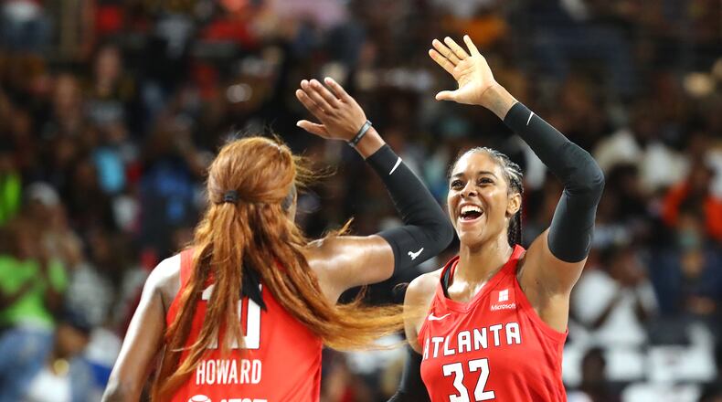 Atlanta Dream guard Rhyne Howard (left) and forward Cheyenne Parker helped lead the team to a home victory Sunday against the Storm. (Curtis Compton / Curtis.Compton@ajc.com)