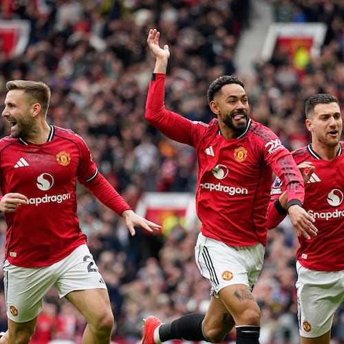 Manchester United's Matheus Cunha, centre, celebrates with teammates after scoring his side's opening goal during the English Premier League soccer match between Manchester United and Liverpool in Manchester, England, Sunday, May 3, 2026. (AP Photo/Dave Thompson)