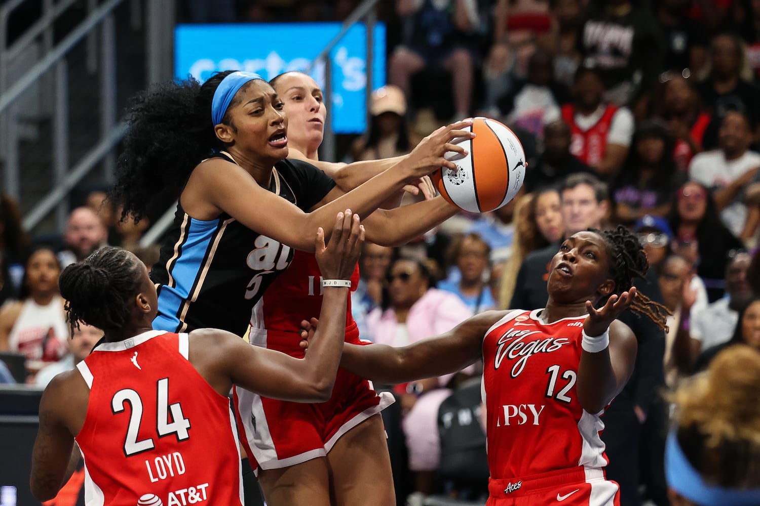 Atlanta Dream forward Angel Reese, left, grabs an offensive rebound against Las Vegas Aces forward Stephanie Talbot, center, guard Jewell Loyd (24) and guard Chelsea Gray (12) during the second half of a WNBA game at State Farm Arena on Sunday, May 17, 2026, in Atlanta. (Colin Hubbard for the AJC) 