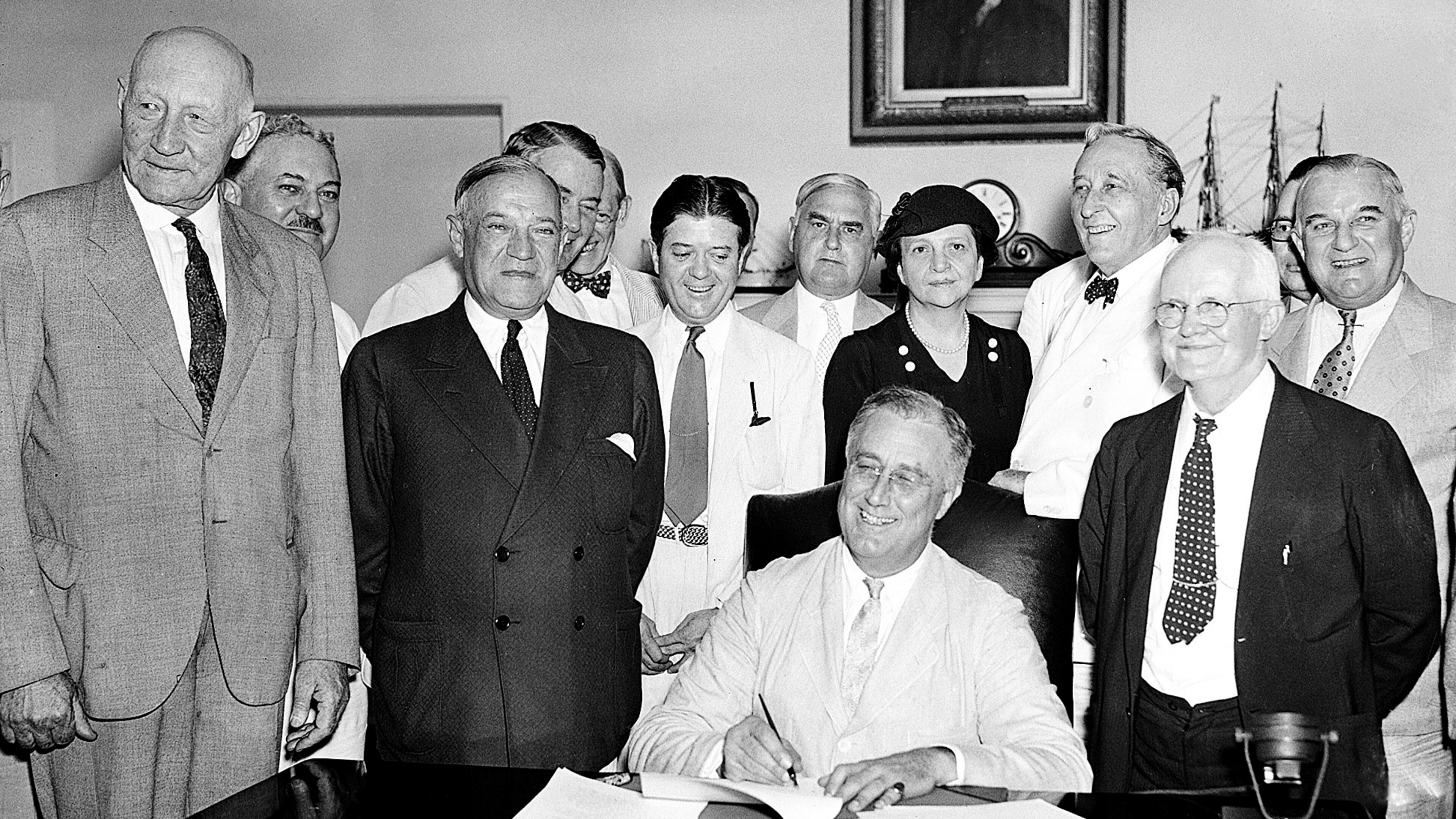 FILE - President Franklin Roosevelt signs the Social Security Bill in Washington Aug. 14, 1935. (AP Photo, File)