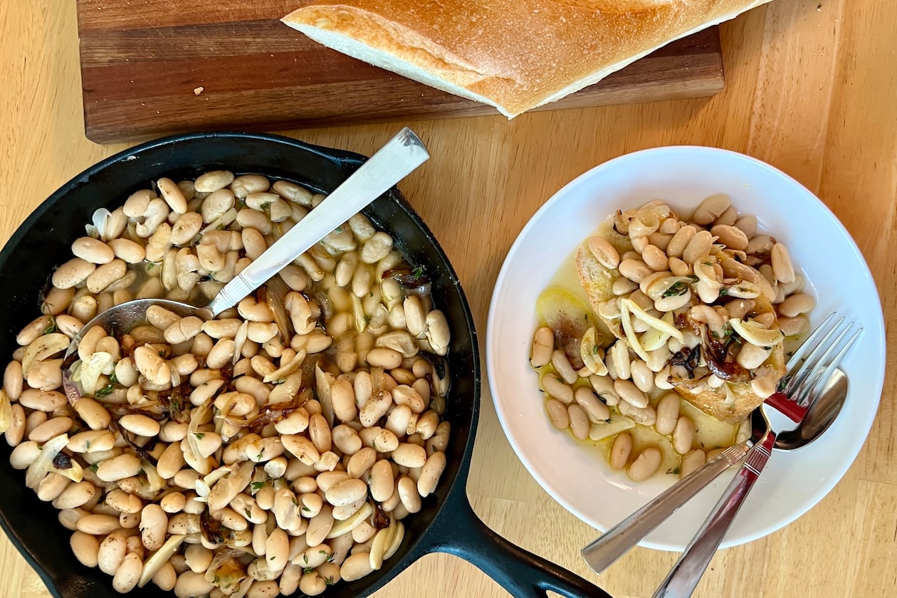 Tuscan white beans flavored with onions, garlic, thyme and broth are equally comforting and convenient. (Virginia Willis for the AJC)