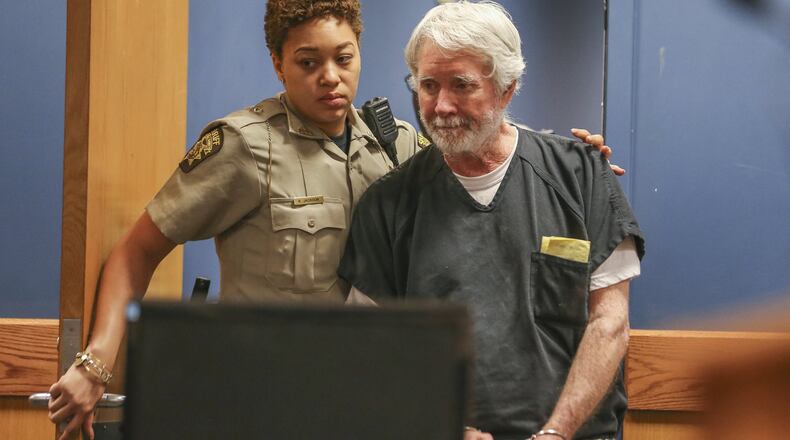 Fulton County deputy K. Jackson brings Claud “Tex” McIver into the courtroom during a recent court date. The Atlanta attorney has been charged with malice murder in the shooting death of his wife, business executive Diane McIver. He says it was an accident. JOHN SPINK/JSPINK@AJC.COM