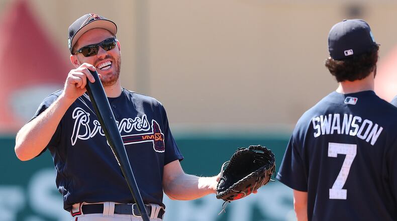 Freddie Freeman shares a laugh with Dansby Swanson during a Feb. 20 workout. Freeman returned to the lineup Wednesday after missing 1 1/2 weeks while at the World Baseball Classic. Swanson has been out since March 4 with back tightness. (Curtis Compton/ccompton@ajc.com)