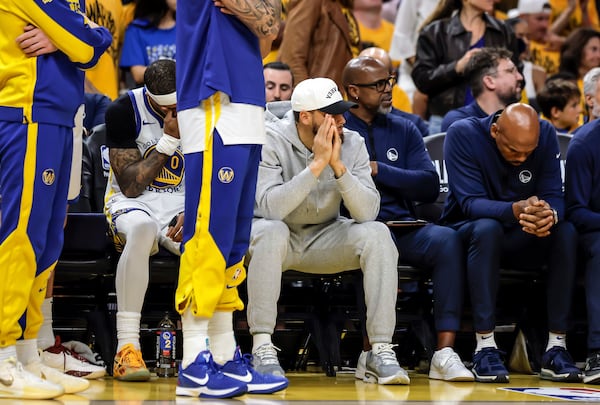 Golden State Warriors' Stephen Curry (30) and other players watch from the bench during Game 3 of an NBA basketball second-round playoff series against the Minnesota Timberwolves in San Francisco, Saturday, May 10, 2025. (Carlos Avila Gonzalez/San Francisco Chronicle via AP)