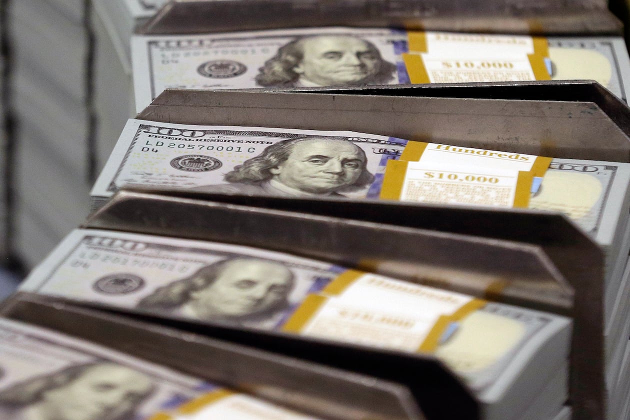 Freshly cut stacks of $100 bills make their way down the line at the Bureau of Engraving and Printing Western Currency Facility in Fort Worth, Texas. More Georgians are defaulting on their student loans, according to new reporting by the Associated Press. (AP FILE)