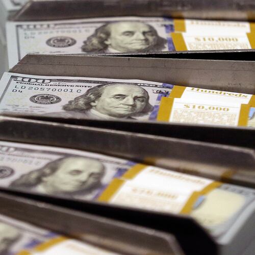 Freshly cut stacks of $100 bills make their way down the line at the Bureau of Engraving and Printing Western Currency Facility in Fort Worth, Texas. More Georgians are defaulting on their student loans, according to new reporting by the Associated Press. (AP FILE)