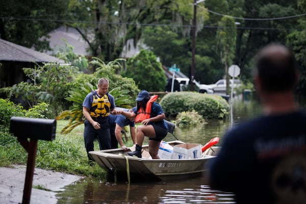  Firefighters with Savannah Fire rescue a resident from their home amid floodwaters after Tropical Storm Debby came through Savannah, Ga., on Tuesday, Aug. 6, 2024. (Dustin Chambers/The New York Times) 