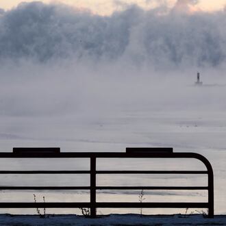 Doug Kunde watches as steam is seen over Lake Michigan as frigid temperatures for the day are not expected to reach zero degrees Friday, Jan. 23, 2026, in Milwaukee. (AP Photo/Morry Gash)