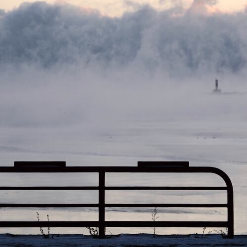 Doug Kunde watches as steam is seen over Lake Michigan as frigid temperatures for the day are not expected to reach zero degrees Friday, Jan. 23, 2026, in Milwaukee. (AP Photo/Morry Gash)