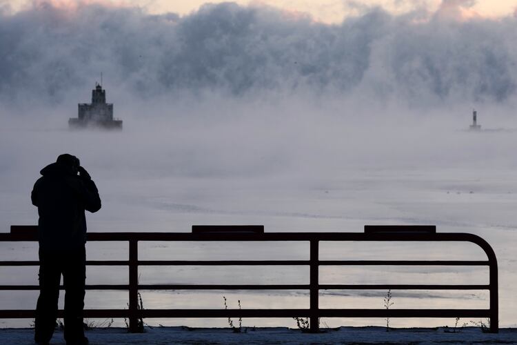 Doug Kunde watches as steam is seen over Lake Michigan as frigid temperatures for the day are not expected to reach zero degrees Friday, Jan. 23, 2026, in Milwaukee. (AP Photo/Morry Gash)