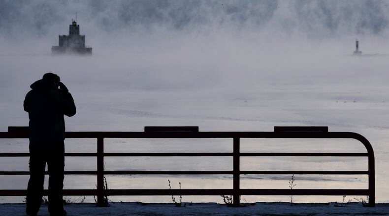 Doug Kunde watches as steam is seen over Lake Michigan as frigid temperatures for the day are not expected to reach zero degrees Friday, Jan. 23, 2026, in Milwaukee. (AP Photo/Morry Gash)