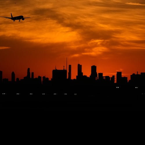 An airplane descends to land at O'Hare International Airport in Chicago, Wednesday, Nov. 12, 2025. (AP Photo/Nam Y. Huh)