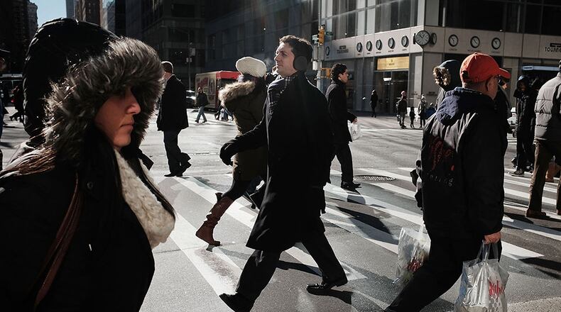 NEW YORK, NY - JANUARY 05: People walk along a street in midtown Manhattan after a recent cold spell on January 5, 2016 in New York City. Following weeks of some of the warmest temperatures on record, New York City and much of the Northeast is experiencing typical winter weather with temperatures in the lower 30's.The recent drop in temperatures has brought relief to ski areas and other winter dependent businesses. (Photo by Spencer Platt/Getty Images)