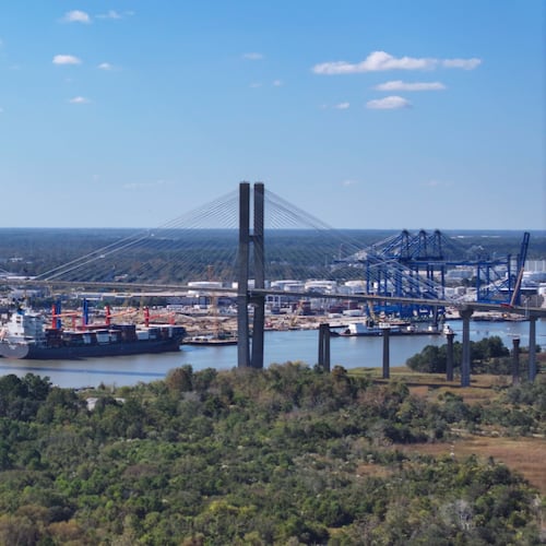 An aerial image of the Talmadge Bridge above the Savannah River with the Georgia Ports Authority Ocean Terminal in the background. (Miguel Martinez/AJC)
