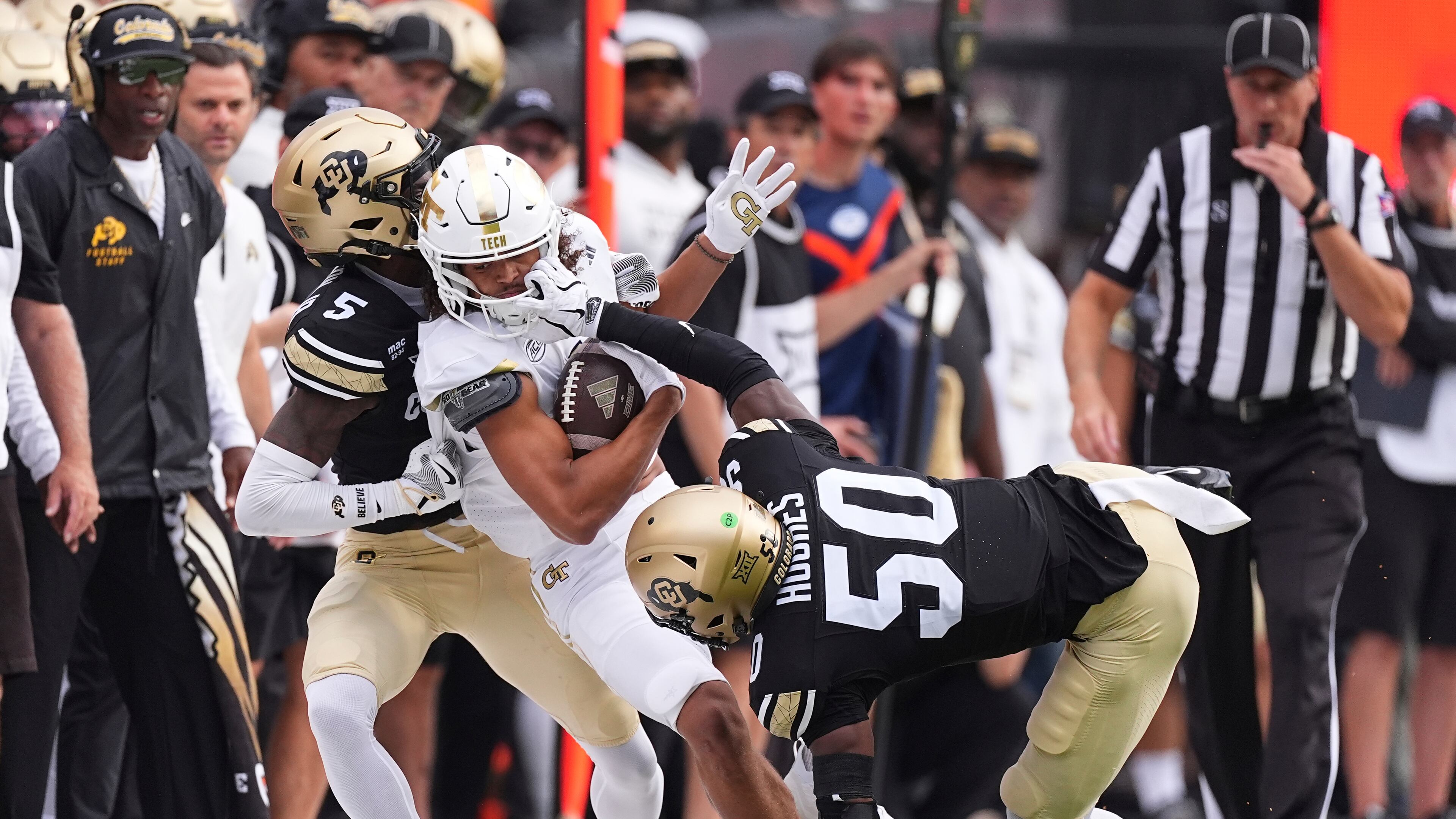 Wide receiver Isiah Canion (center) pulls down a pass and gets tackled by Colorado's Preston Hodge (left) and Reginald Hughes on Friday, Aug. 29, 2025, in Boulder, Colo. The Yellow Jackets won 27-20. (David Zalubowski/AP)