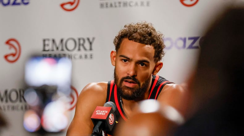 Trae Young, pictured answering questions during media day in September, scored nine points with eight assists in 18 minutes in the Hawks' preseason opener against the Rockets. (Miguel Martinez/AJC)