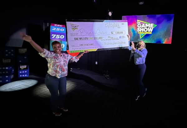 The Game Show Challenge on the West End of Atlanta provides winners with a fake $1 million check. Kimberly Troutman (left) of Stockbridge and Lakisha Brown of Dallas beat two friends on Friday, May 15, 2026. (Rodney Ho/AJC)