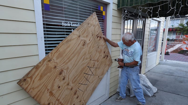 Local resident and business owner Jimmy Mock returns to his St. Marys general store on Thursday, Sept. 5, 2019, taking the boards down to begin moving merchandise back in and reopening the business after Hurricane Dorian. Mock’s business appeared to have escaped with minor wind damage. CURTIS COMPTON / CCOMPTON@AJC.COM