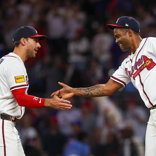 Braves first baseman Matt Olson (left) celebrates a 5-2 win against the Cubs with pitcher Raisel Iglesias on Tuesday, May 12, 2026, at Truist Park in Atlanta. The 2026 Braves are dominating the NL East like no other team ever has at this point of the year. (Arvin Temkar/AJC)