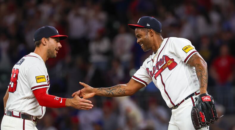 Braves first baseman Matt Olson (left) celebrates a 5-2 win against the Cubs with pitcher Raisel Iglesias on Tuesday, May 12, 2026, at Truist Park in Atlanta. The 2026 Braves are dominating the NL East like no other team ever has at this point of the year. (Arvin Temkar/AJC)