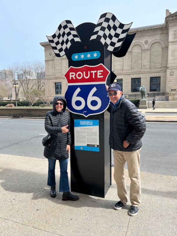 Jerry and Cady Carnes pose in front of a Route 66 sign at the beginning of the famed route in Chicago, on April 1, 2025. Courtesy of Jerry Carnes