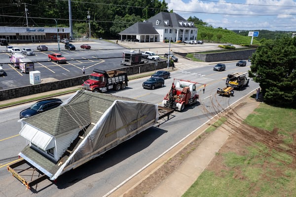 A piece of the historic McAfee house begins its journey from Kennesaw to a new location in Ball Ground. (Ben Gray for The Atlanta Journal-Constitution)