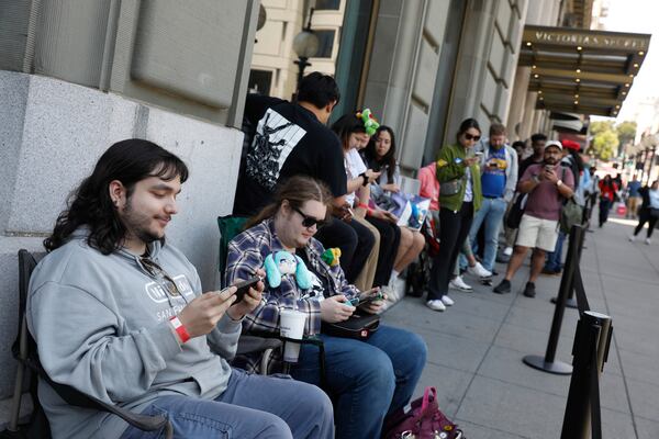 From left to right, Kenneth Knotts, of Danville and Ian Suelter-Davison, of Santa Cruz sit in chairs they brought to wait in line as they wait to enter the Nintendo Store for a pre-launch event for the Ninentdo Switch 2 on Wednesday, June 4, 2025, in San Francisco. (Lea Suzuki/San Francisco Chronicle via AP)