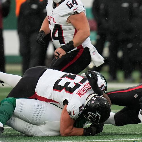 Atlanta Falcons quarterback Kirk Cousins (18) is tackled against the New York Jets during the first half of an NFL football game, Sunday, Nov. 30, 2025, in East Rutherford, N.J. (AP Photo/Seth Wenig)