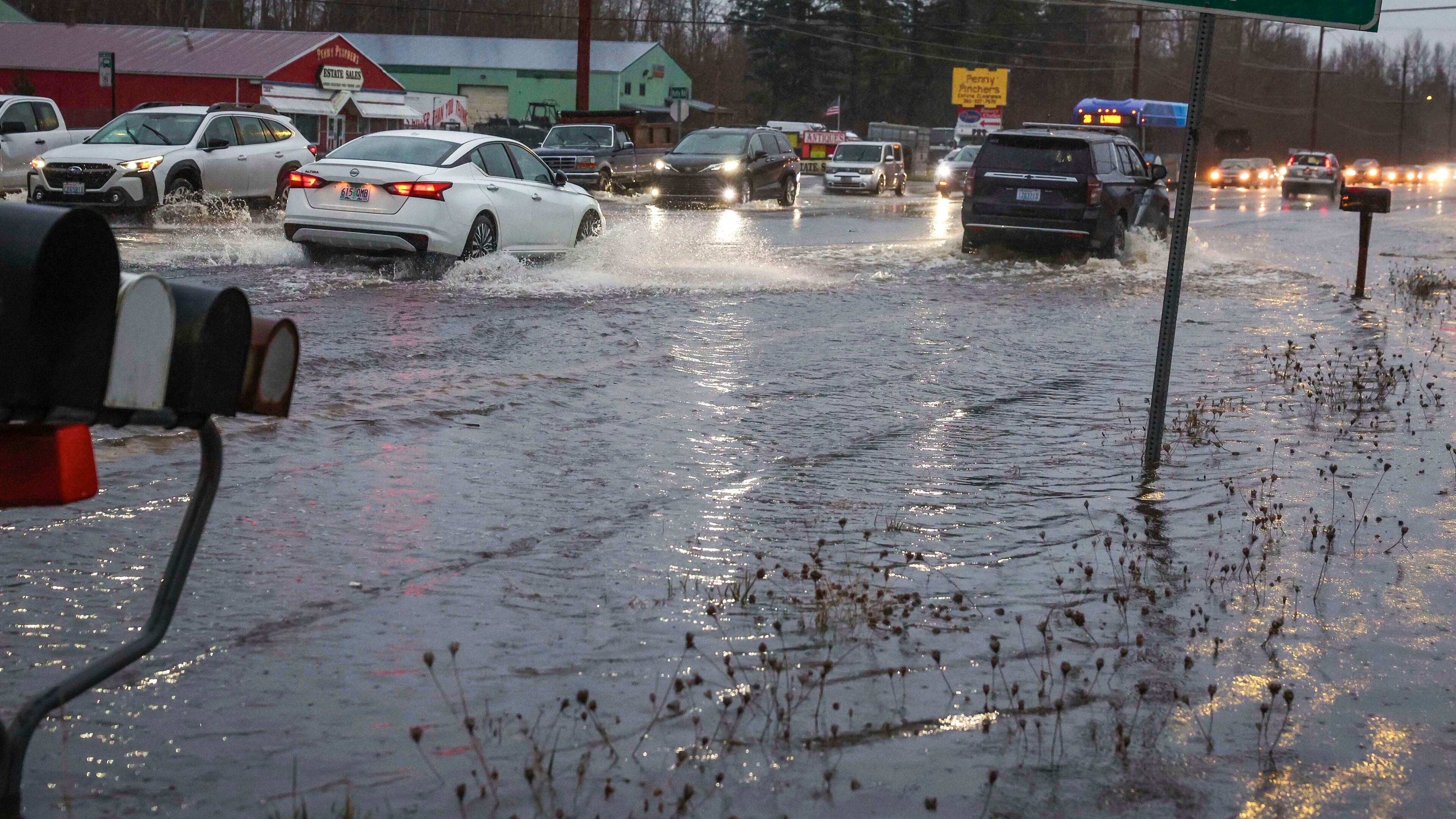 Motorists drive over flooded Guide Meridian Road in Northern Bellingham in Wash., Wednesday Dec. 10, 2025. (Ivy Ceballo/The Seattle Times via AP)