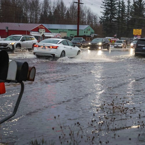 Motorists drive over flooded Guide Meridian Road in Northern Bellingham in Wash., Wednesday Dec. 10, 2025. (Ivy Ceballo/The Seattle Times via AP)