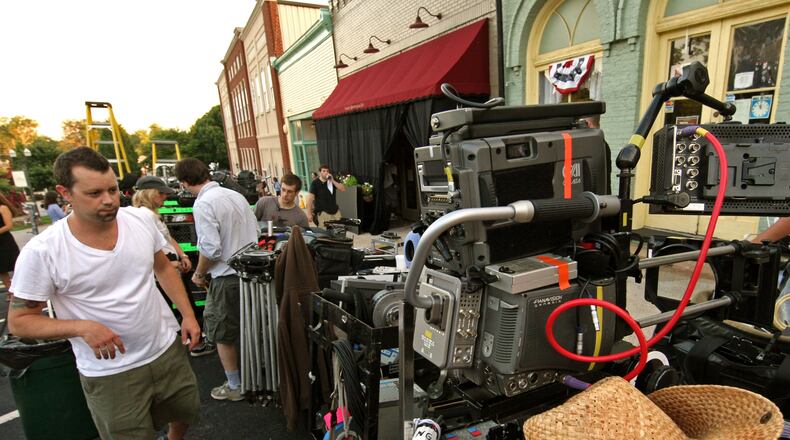 Camera assistant Grady Upchurch of Marietta walks to his area where he prepares a camera during filming for “Drop Dead Diva,” a Lifetime television series, in a retail shop along Main Street in downtown Senoia in 2010. Georgia offers one of the country’s most generous film and TV production tax incentive schemes, having doled out more than $1 billion in credits over the past decade in order to attract studios to the state. Jason Getz jgetz@ajc.com
