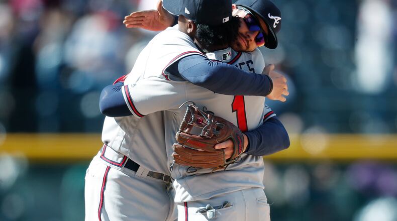 Braves shortstop Dansby Swanson and second baseman Ozzie Albies hug after a recnt win. (AP Photo/David Zalubowski)