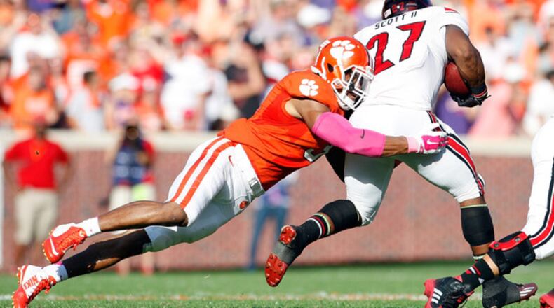 Vic Beasley #3 of the Clemson Tigers makes a tackle on L.J. Scott #27 of the Louisville Cardinals during the game at Memorial Stadium on October 11, 2014 in Clemson, South Carolina. (October 10, 2014 - Source: Tyler Smith/Getty Images North America)