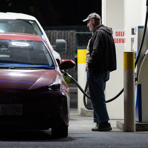 A person fills a tank with fuel at a gas station on Wednesday, May 6, 2026, in Portland, Ore. (AP Photo/Jenny Kane)