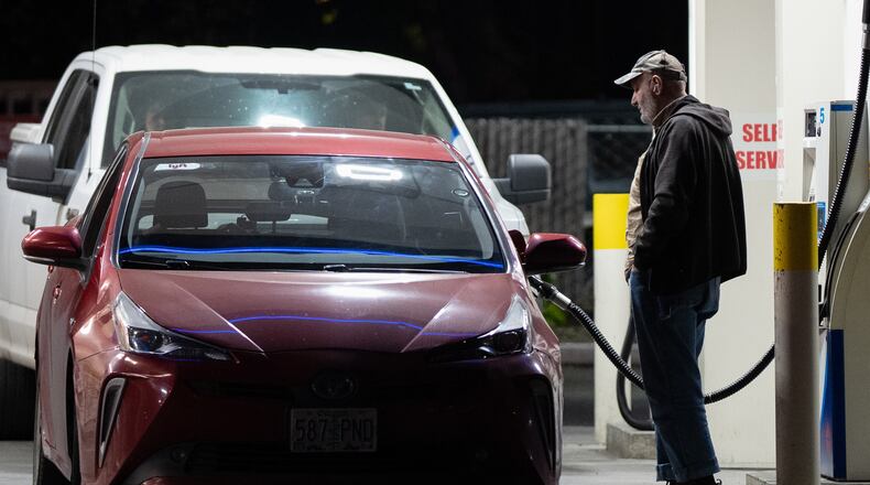A person fills a tank with fuel at a gas station on Wednesday, May 6, 2026, in Portland, Ore. (AP Photo/Jenny Kane)