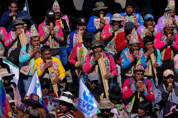 Quechua musicians play flutes in support of former President Evo Morales during a march to the Electoral Tribunal offices in El Alto, Bolivia, Friday, May 16, 2025. (AP Photo/Juan Karita)