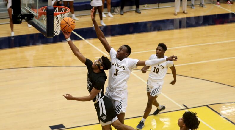 Shiloh guard Caleb Golden (10) attempts a layup against Wheeler forward Ja'Hiem Hudson (3) in the first half of Thursday's game. (Jason Getz/Special to the AJC)